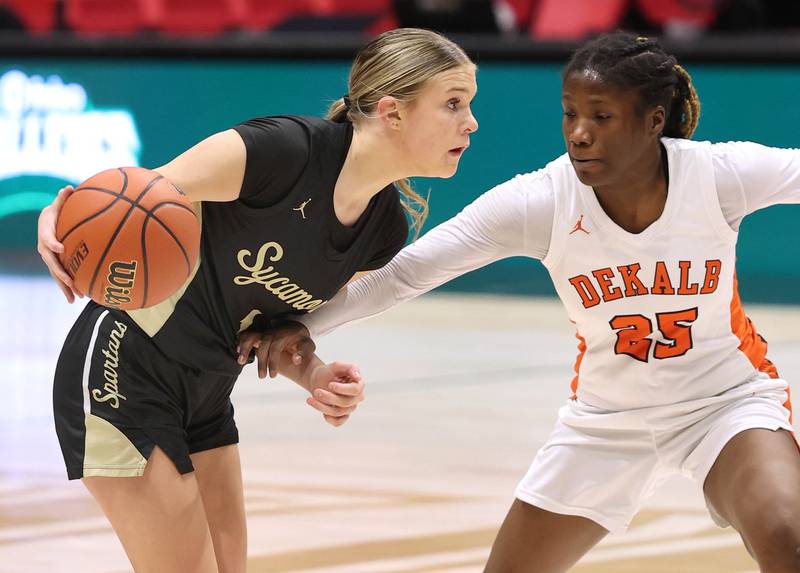 Sycamore's Quinn Carrier works against DeKalb’s Kezaria Mitchell during their game Friday, Jan. 26, 2024, in the FNBO Challenge in the Convocation Center at Northern Illinois University.