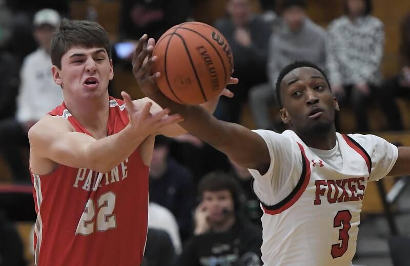 Palatine’s Tommy Elter and Yorkville’s Dayvion Johnson reach for the ball in a quarterfinal game of the Jack Tosh Classic at York High School in Elmhurst on Thursday, Dec. 28, 2023.
