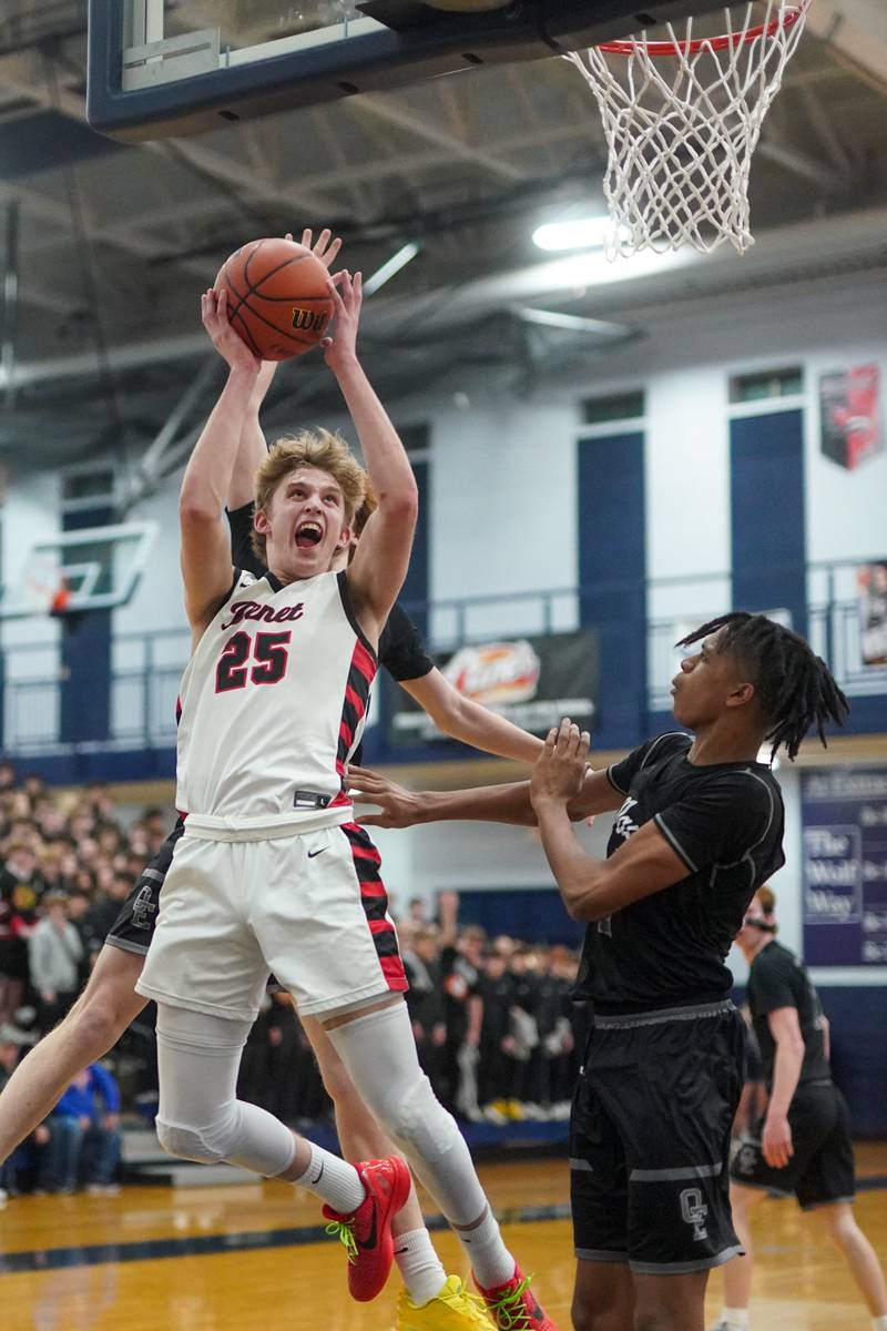 Benet’s Gabriel Sularski (25) drives to the hoop against Oswego East's Mason Lockett IV (2) and  Noah Mason (back) during a Class 4A Oswego East regional final basketball game at Oswego East High School on Friday, Feb 23, 2024.