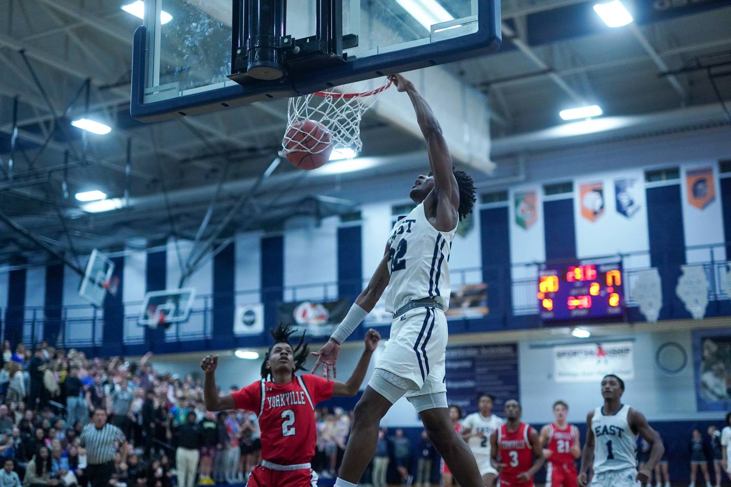 Oswego East's Jehvion Starwood (22) dunks the basket ball during a basketball game against Yorkville at Oswego East High School on Friday, Dec 8, 2023.