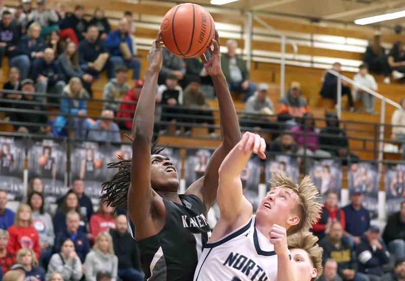 Kaneland's Freddy Hassan grabs a rebound over Belvidere North's Joseph Brown Wednesday, Feb. 28, 2024, during their Class 3A sectional semifinal game at Kaneland High School in Maple Park.