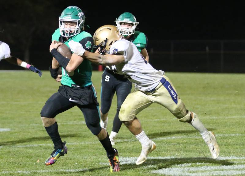 Seneca quarterback Paxton Giertz is taken down by Marquette's Payton Gutierrez on Friday, Oct. 18, 2024 at Seneca High School.