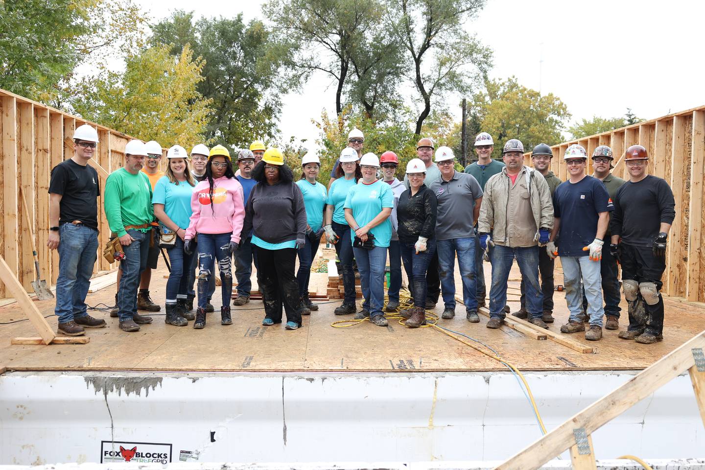 Volunteers from CITCO and Habitat for Humanity pose for a photo at a home being built by Habitat for Humanity on Wednesday, Oct. 25, 2023 in Lockport.