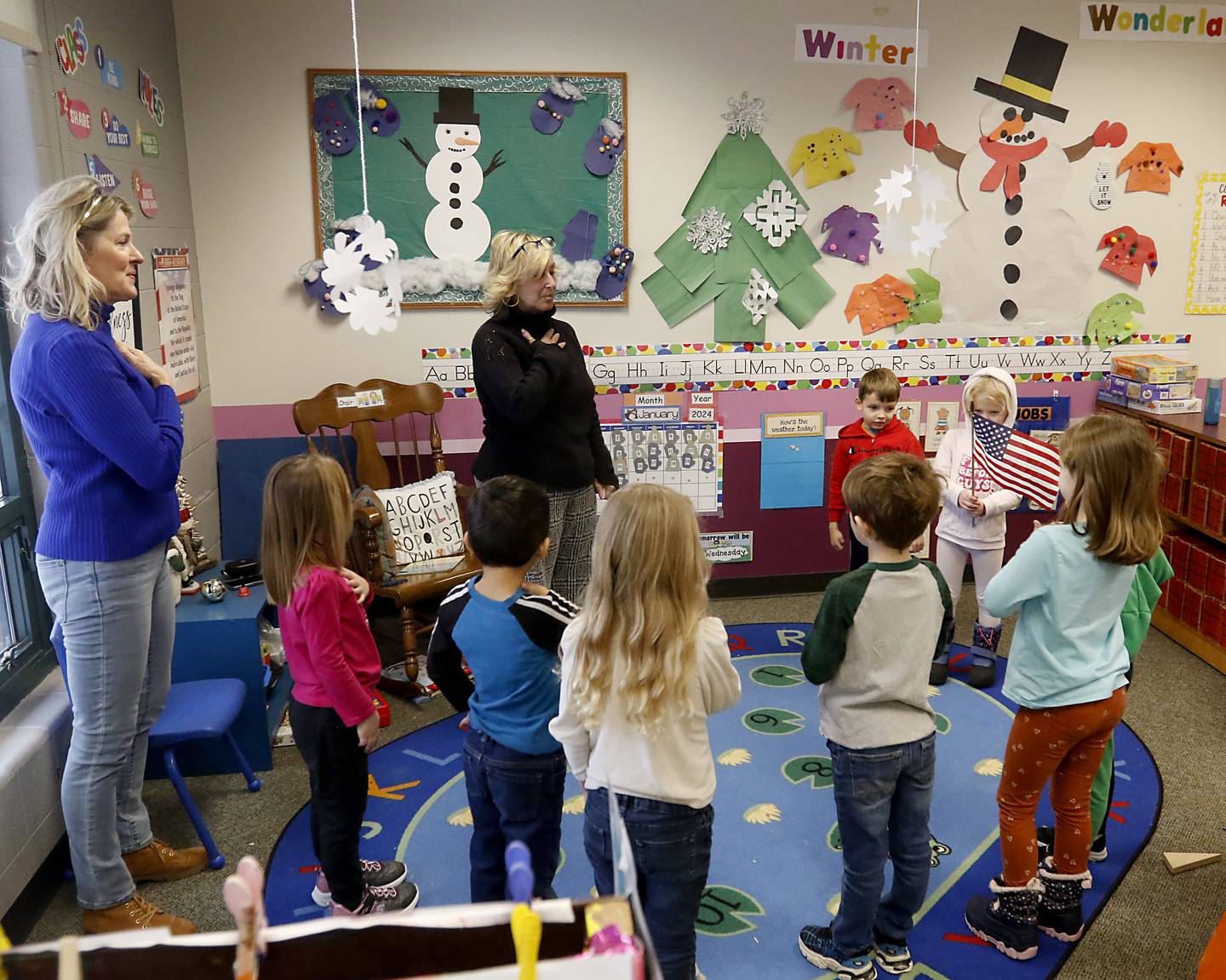 Teachers Cheryl Covert and Lisa Knoeppel lead their students in the “Pledge of Allegiance” during circle time on Tuesday Jan. 23, 2024, at the Purple Moose in Crystal Lake. The preschool will close down after the current school year finishes in June, unless the school can find another location after the Shiloh Church decided not to renew the preschool's lease.