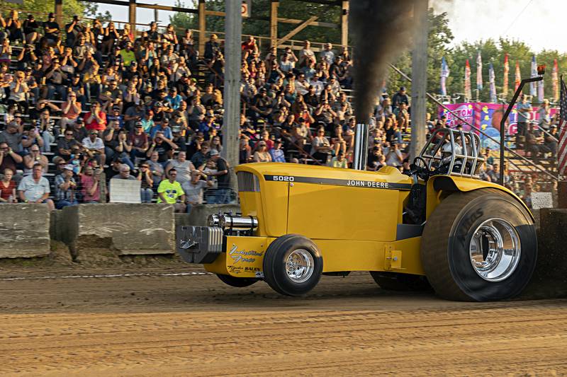 Jason Rauen hauls past the grand stand at the Badger State Tractor Pullers event Wednesday, August 9, 2023 at the Carroll County fair.