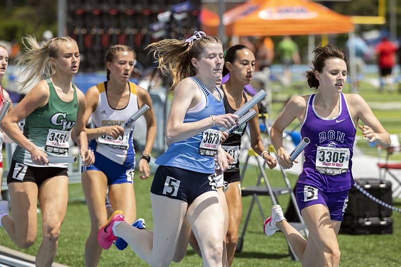 Downers Grove North’s Sarah Paul leads a pack  in the 3A 4x800 Saturday, May 18, 2024 at the IHSA girls state track meet in Charleston.