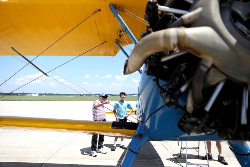 Ray Smith (left) of South Elgin and his grandson, Mason Erling, 12, of Huntley look at a PT-13 Stearman as part of the Commemorative Air Force’s AirPower History Tour at the DuPage Flight Cente in West Chicago.