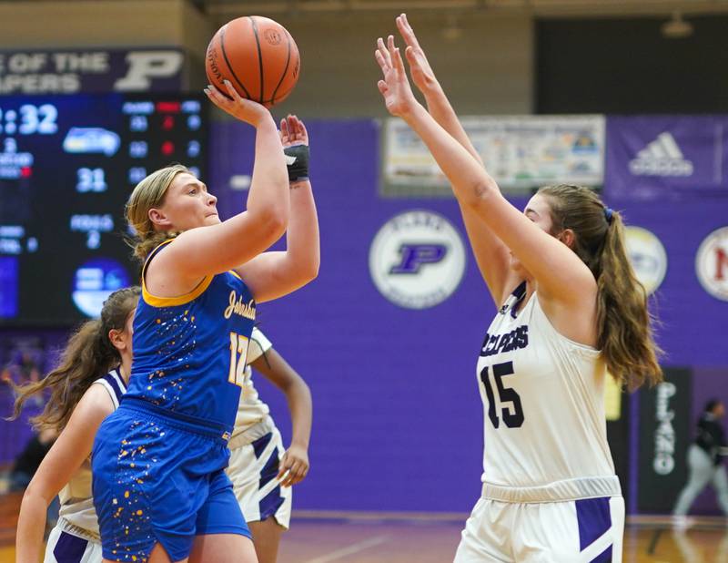 Johnsburg's Kaylee Fouke (12) shoots the ball against Plano's Chloe Rowe (15) during a basketball game at Plano High School on Tuesday, Jan 30, 2024.