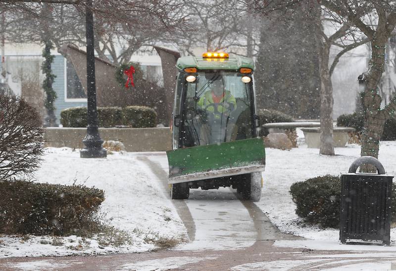 Sidewalks in Depot Park are salted in downtown Crystal Lake as the snow begins to fall Thursday, Dec. 22, 2022, as a winter storm hits northern Illinois.