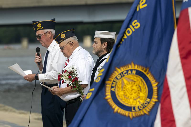 Jim Devine (left), Dwight Moss and Dave Devine start a ceremony Monday, May 27, 2024 at the Dixon riverfront to pay tribute to those who lost their lives at sea.