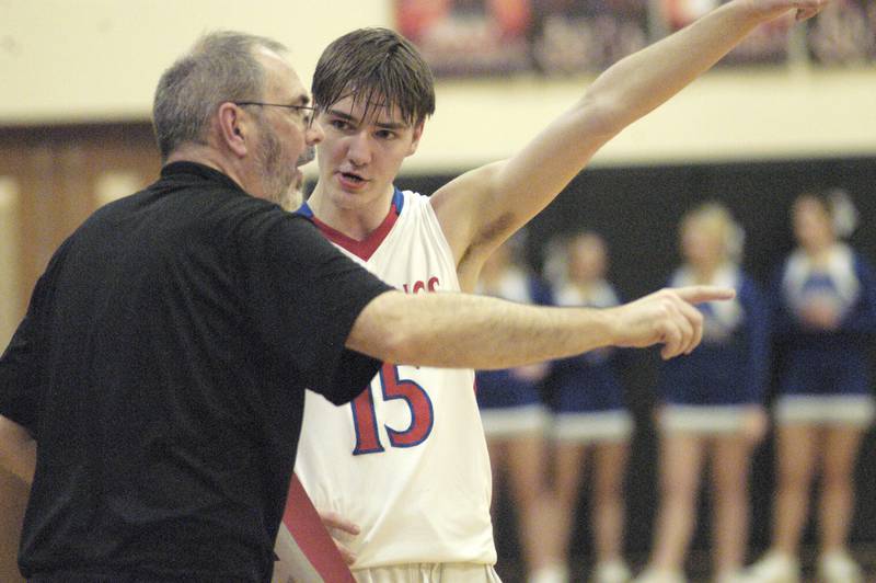 Morrison head coach Mark Ernst talks stragety wirh player Asher Ernst during the Morrison vs Princeton class 2A basketball regional final at Prophetstown High School on Friday, Feb. 23 .