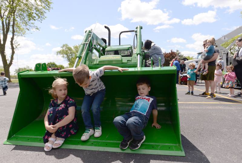 (left-right) Molly, Lucas and Matthew Modrowski of Western Springs play inside a plow while attending the LaGrange Park District's Touch A Truck event held at Sedgwick Park Saturday May 11, 2024.