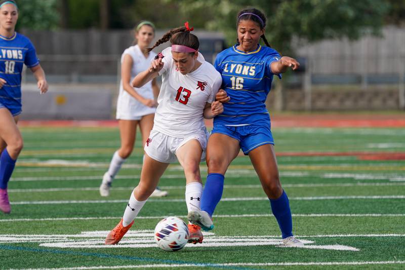 Hinsdale Central's Piper Bingham (13) challenges Lyons’ Leahla Frazier (16) for the ball during a Class 3A Hinsdale Central Sectional semifinal soccer match at Hinsdale Central High School in Hinsdale on Tuesday, May 21, 2024.