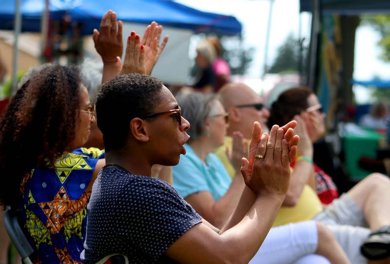 Jordan Harris of Crystal Lake enjoys live music with others during McHenry County’s 2nd Annual Juneteenth Festival at the Woodstock Square Saturday.