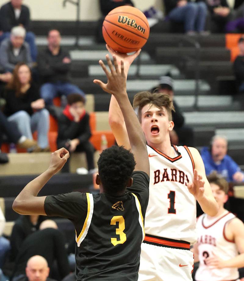 DeKalb’s Jackson Kees shoots over Metea Valley's Tre Watkins during their game Friday, Jan. 19, 2024, at DeKalb High School.