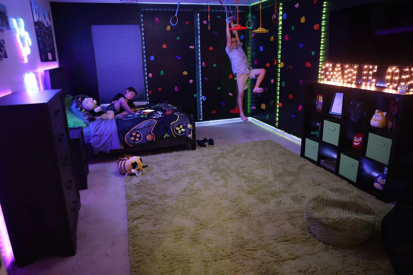 Blake Baras, 8-years old, right, swings on one of the fun feature of Jorgie Espinoza newly renovated room. Jorgie, who is battling cancer, won an extreme bedroom makeover from Special Places, an organization creating dream bedrooms for children with cancer on Tuesday, Sept. 12, in Joliet.