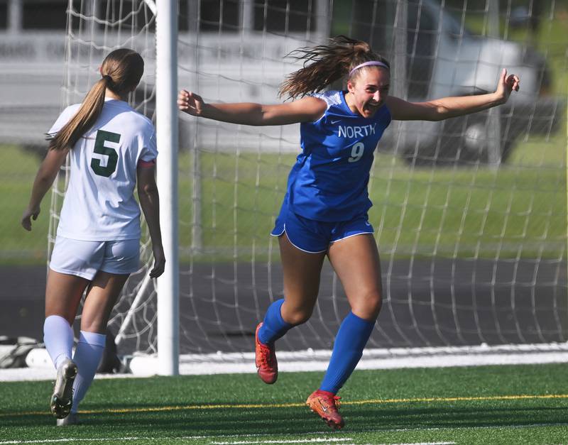 Wheaton North's Talia Kaempf (9) celebrates her first goal of the game past Glenbard West's Ellie Beaudoin (5) during the Class 3A regional soccer championship game on Friday, May 17, 2024 in Elgin.