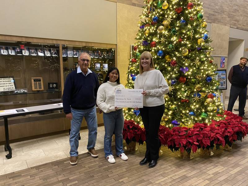 Shan B. donates $500 to Operation St. Nick as a second place finisher in the Community Foundation of Grundy County's essay contest.