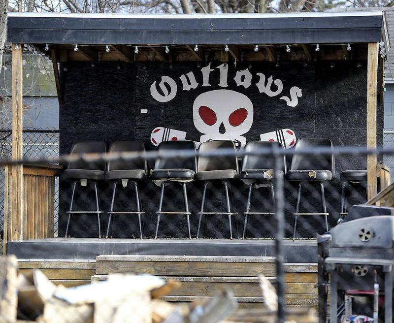 A painted Outlaws logo stands behind several seats Wednesday, Dec. 20, 2017, at the motorcycle club's clubhouse in Joliet, Ill.