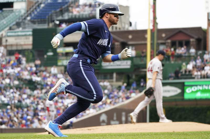 Chicago Cubs' Ian Happ runs to first base after hitting a double during the first inning of a baseball game against the Boston Red Sox in Chicago, Friday, July 1, 2022. (AP Photo/Nam Y. Huh)