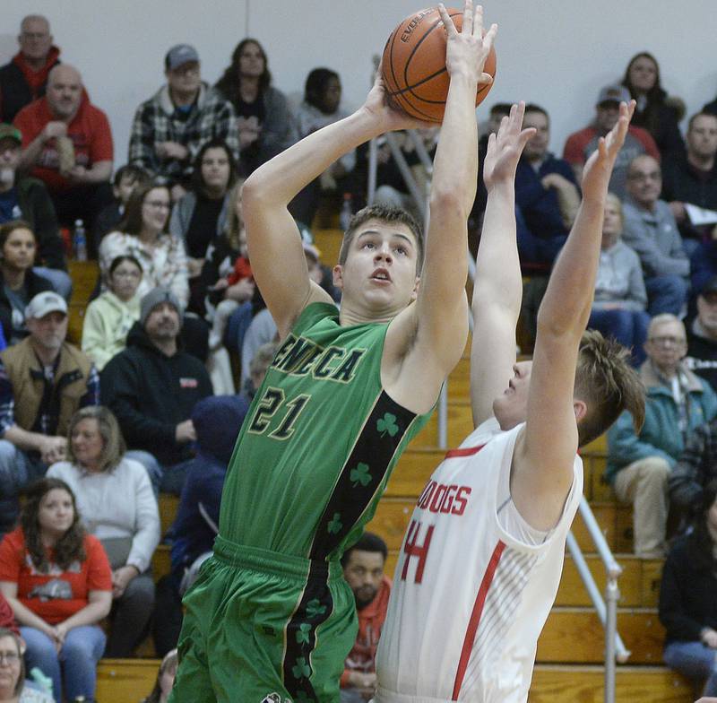 Seneca’s Lane Provance goes up and around Streator’s Nolan Lukach to score in the 1st period in Pops Dale Gymnasium on Tuesday Feb. 7, 2023 at Streator High School.