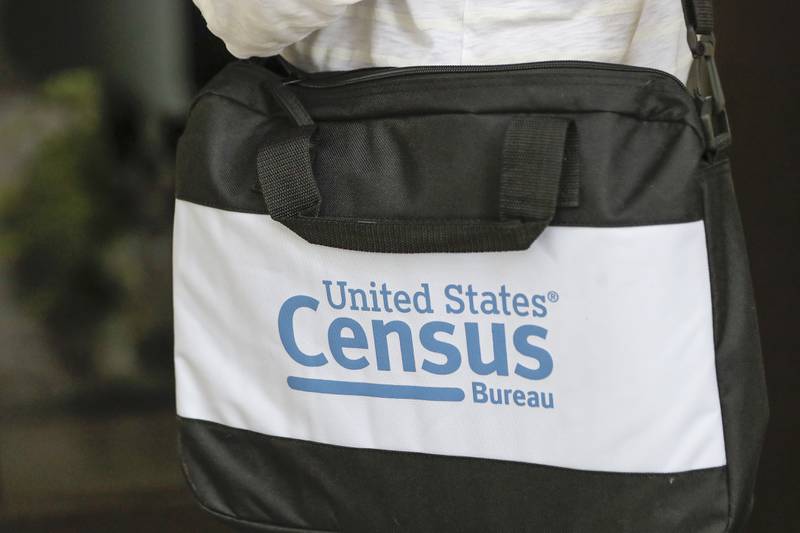 FILE - The briefcase of a census taker is seen as she knocks on the door of a residence, Aug. 11, 2020, in Winter Park, Fla. Eleven small cities in Illinois and Iowa are the only municipalities so far to have signed agreements with the U.S. Census Bureau for a second count of their residents in 2024, the first year the special censuses can be conducted, in a repeat of what happened during the 2020 census. (AP Photo/John Raoux, File)