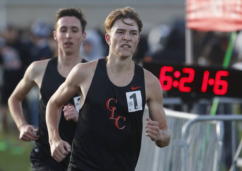 Crystal Lake Central’s Aiden Shulfer
 Runs ahead of his teammate, Karson Hollander, as competes in the 3200 meter run Friday, April 21, 2023, during the McHenry County Track and Field Meet at Cary-Grove High School.