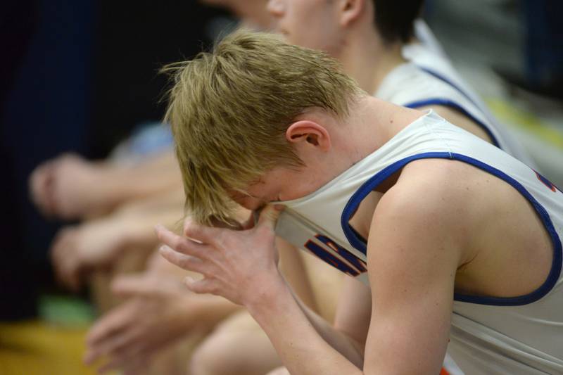 Eastland's Adam Awender (12 ) wipes his face with his jersey in the finals seconds of the Cougars' loss to Pecatonica at the championship game of the 1A River Ridge sectional on Friday, March 1, 2024 in Hanover.