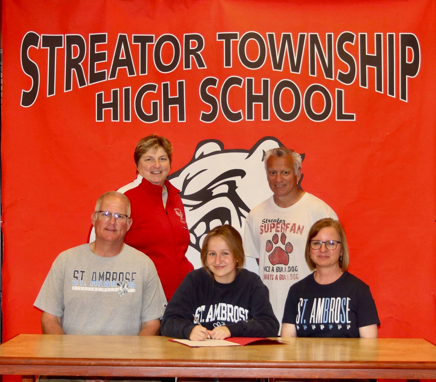 Recent Streator High School graduate Claire Vogel has committed to continue her academic career at St. Ambrose University and her tennis career at the NAIA level with the Fighting Bees. Pictured here is Vogel bookended by her parents, Denny and Ellen Vogel. Standing behind are Streator High tennis coaches Kaye Tallier and John Sandoval.