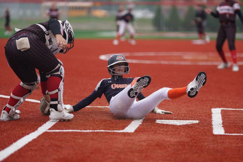 Oswego’s Kaylee LaChappell (11) slides in to home for a score against Yorkville during a softball game at Yorkville High School on Thursday, May 9, 2024.