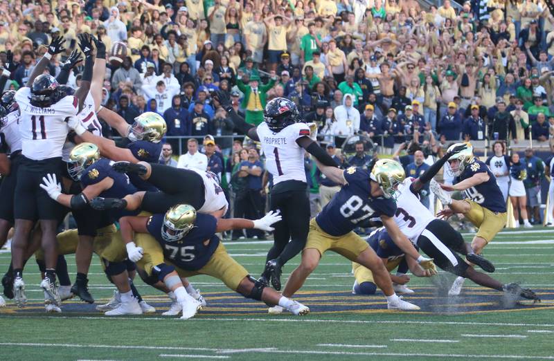 Members of the NIU football team block Notre Dame's field goal to win the game on Saturday, Sept. 7, 2024 at Notre Dame Stadium.