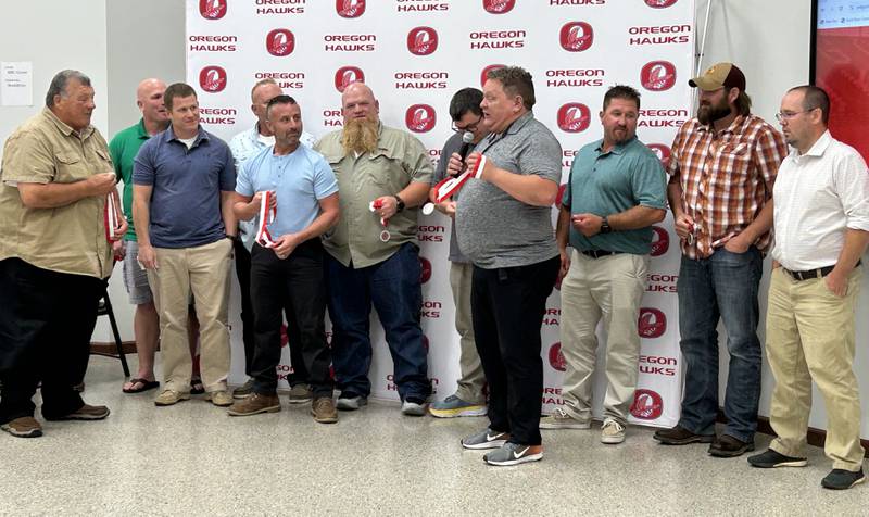 Forner OHS wrestling coach Mike Papini (left) stands with members of the 1998 wrestling team, after being inducted into the OCUSD Hall of Fame during a ceremony on Saturday, Sept. 14, 2024 at the Rock River Center in Oregon. The team won the Class A title in 1998.