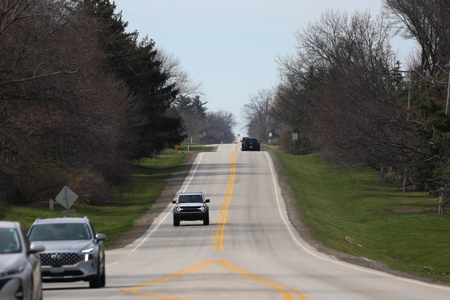 Traffic moves along 143rd Street on an open stretch of road between Lemont and Bell Road on Tuesday, March 19, 2024 in Homer Township.