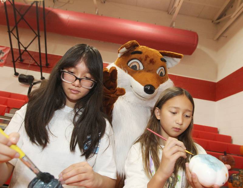 Alexa Collantes, 12, and her cousin, Olivia Caldwell, 9, both of Spring Grove paint pumpkins as the mascot for Stanton watches them during the Dia de los Muertos, Day of the Dead event at Stanton Middle School on November 4th in Fox Lake. The event was sponsored by the Bilingual Parents Advisory Committee (BPAC) from School Districts 114,124 and 37.
Photo by Candace H. Johnson for Shaw Local News Network