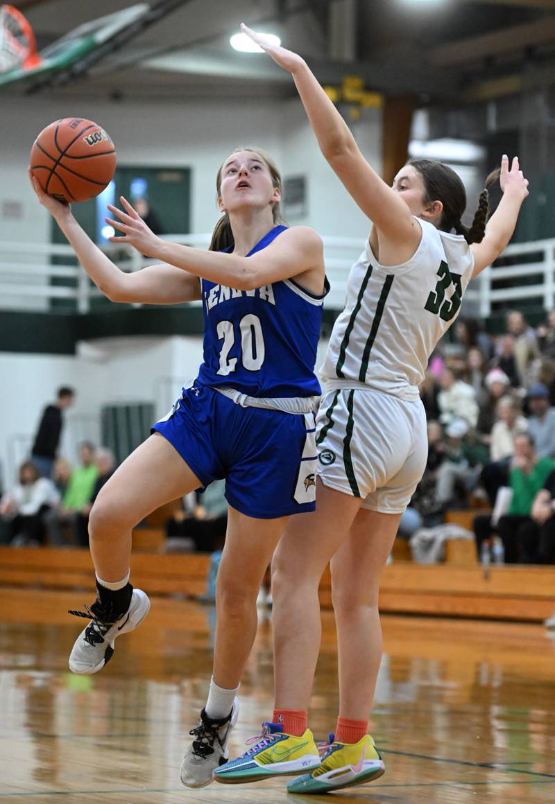 Geneva’s Caroline Madden, left, goes to the basket for a shot against Glenbard West’s Makenna Yeager during the Glenbard West Class 4A girls basketball regional final on Thursday, Feb. 15, 2024 in Glen Ellyn.