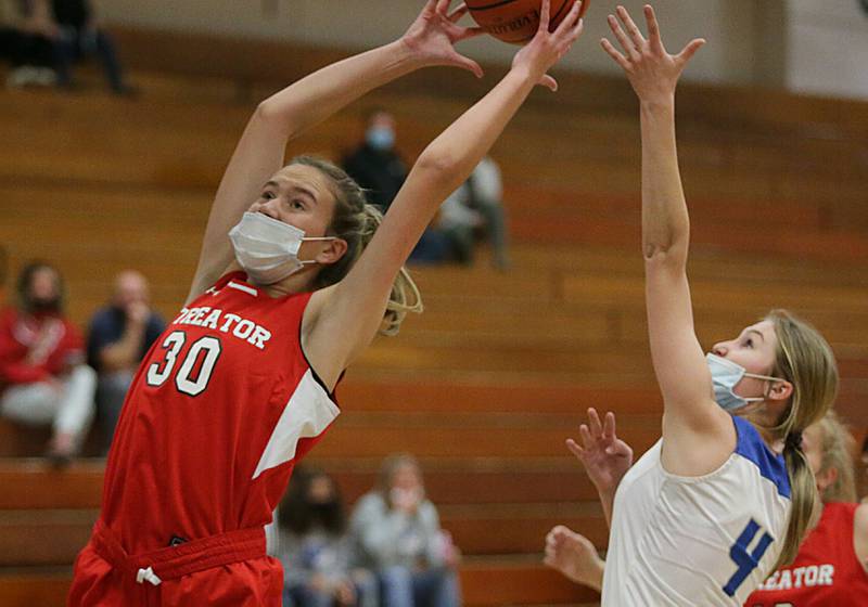 Streator's Marissa Vickers (30) grabs a rebound in front of Princeton's Erian May (4) during the Lady Tigers Holiday Tournament last season.