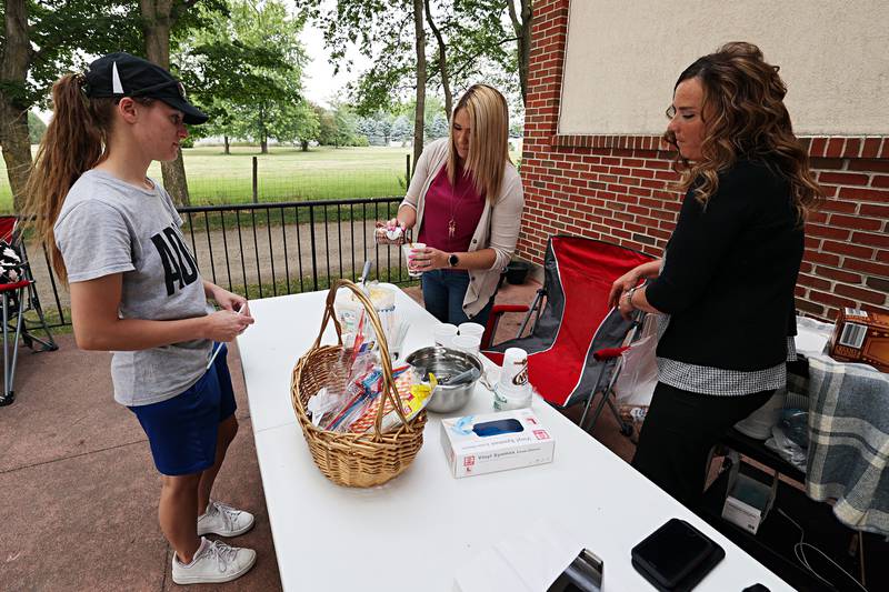 Tiffany O’Dell (middle) Franklin Grove Assisted Living admin and Jenni Winterland of Unity Hospice dishes up root beer floats Friday, June 23, 2023 during a car show and contest at Franklin Grove Assisted Living.