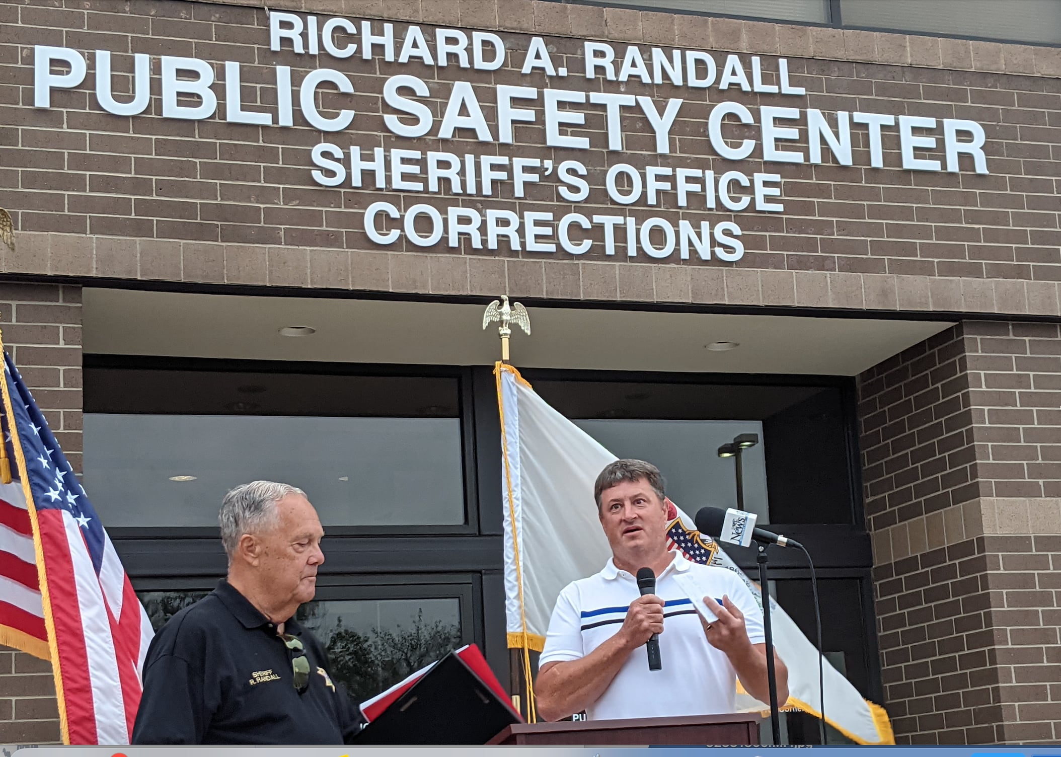 Kendall County Board Chairman Matt Kellogg, right, on Aug. 6 helped dedicate the Kendall County Public Safety Center to former Kendall County sheriff Richard Randall, left.