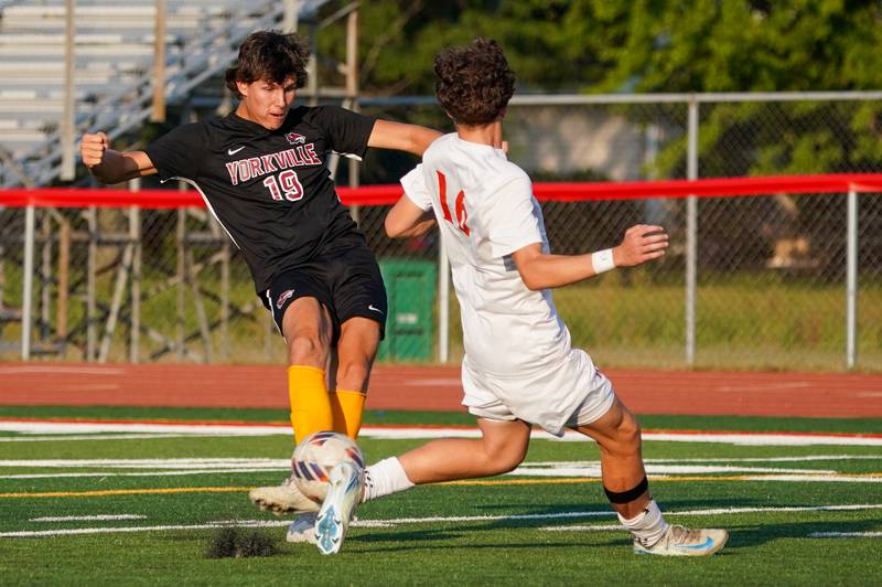 Yorkville's Kyle Nadler (19) shoots the ball against Oswego’s Julian Lopez (14) during a soccer match at Yorkville High School on Tuesday, Sep 17, 2024.