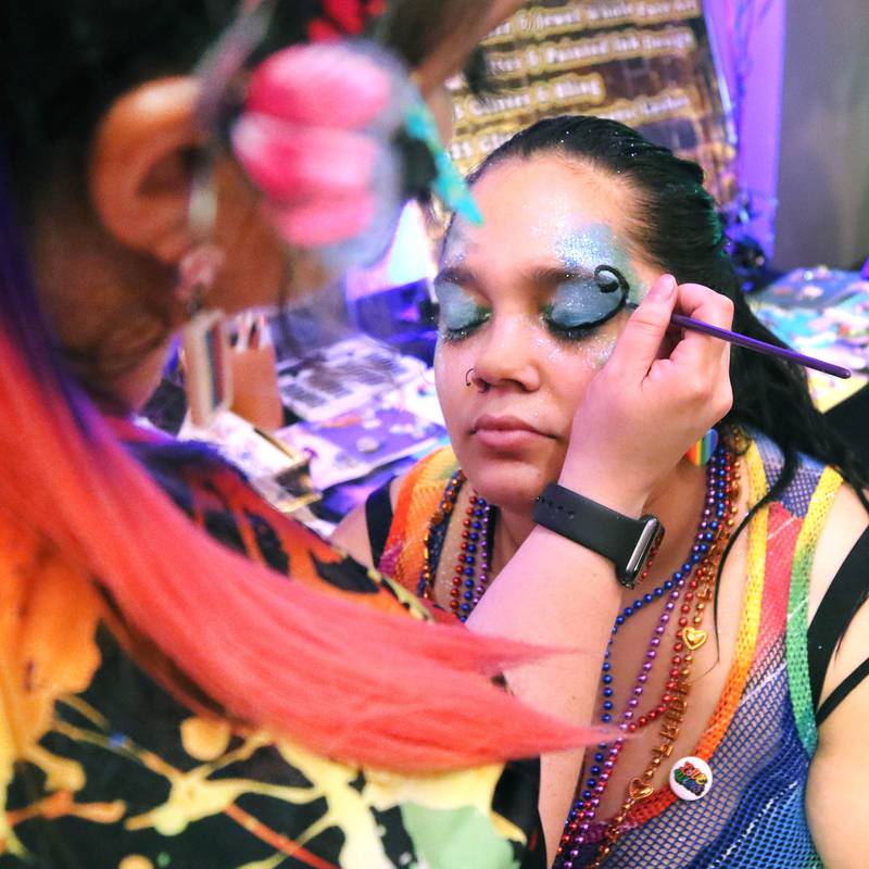 Kyla Jamar, from DeKalb, gets made up by Felicia Hendricks, owner of Paint Time Fun Face Painting, Thursday, June 20, 2024, during DeKalb Pride Fest at the Egyptian Theatre.