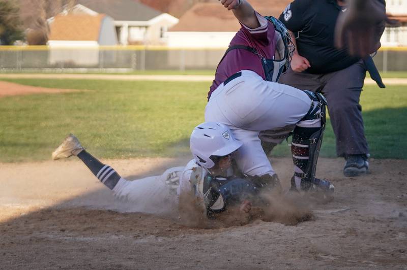 Plano's Amari Bryant (10) slides into home for a run against Marengo’s Drew Litchfield (19) during a baseball game at Plano High School on Monday, April 8, 2024.