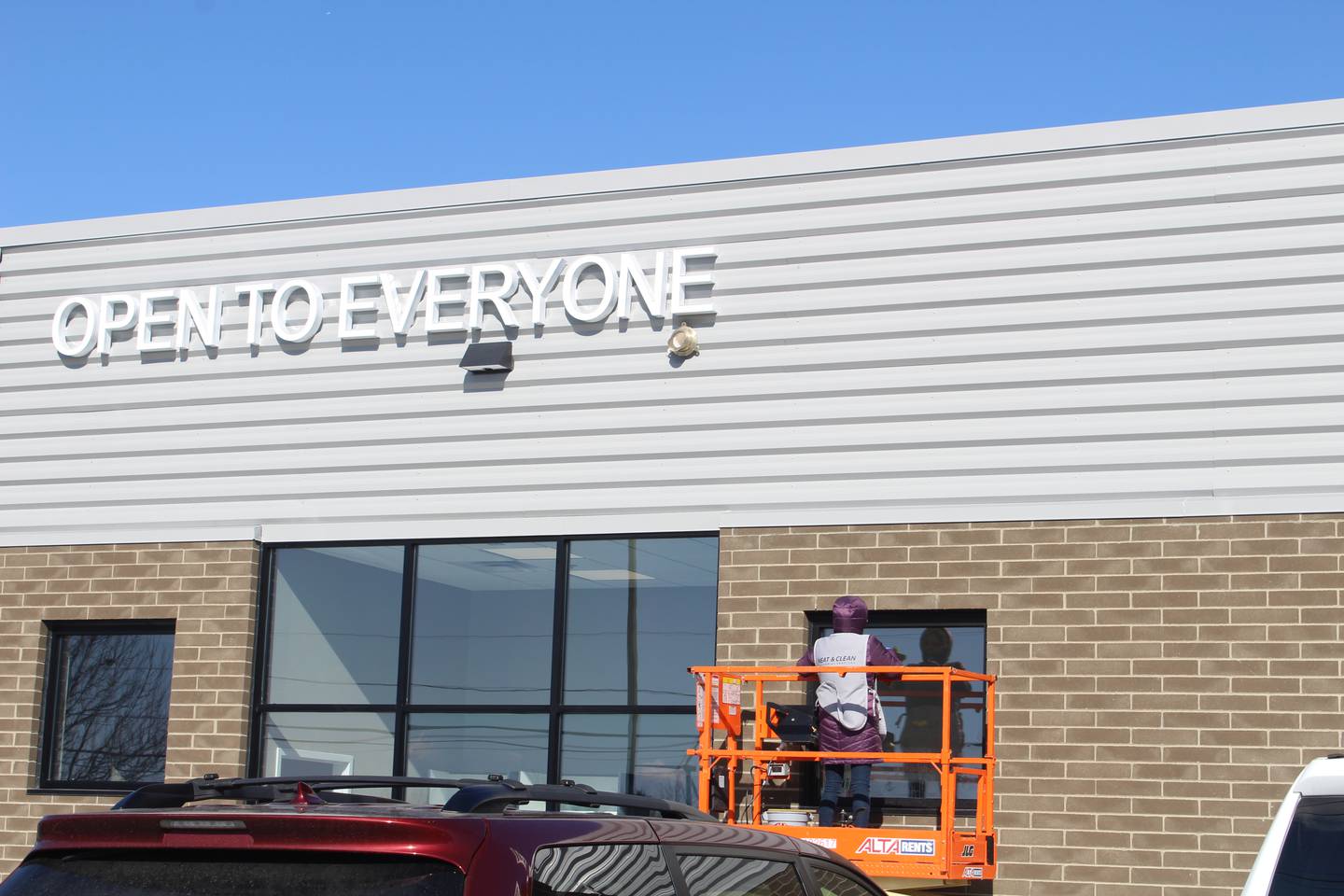Workers complete finishing touches on the exterior of The Food Shed Co-Op in Woodstock which expects to open this spring.