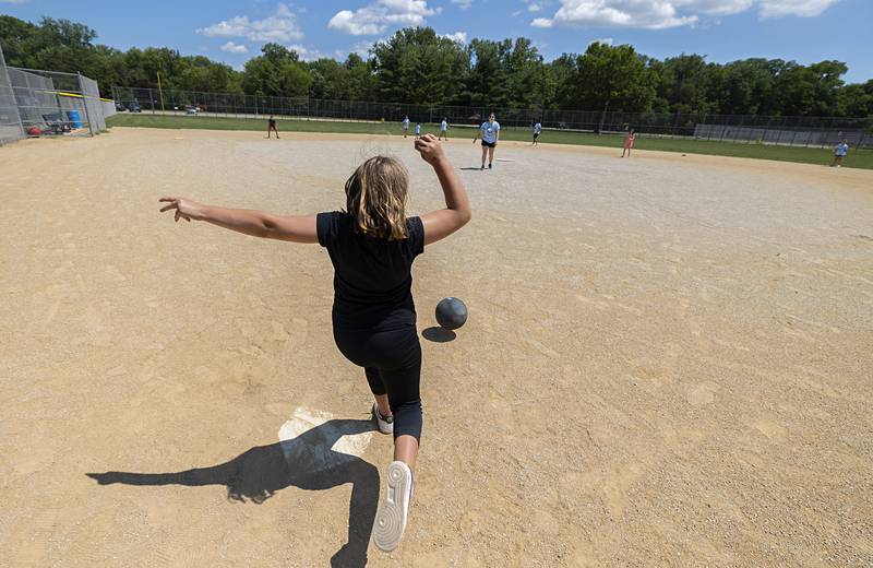 Raleigh Hollaway, 8, loads up to kick the ball during a game Thursday, July 20, 2023 at Centennial Park in Rock Falls. On the final day of the field trip program, kids ate pizza, played on an inflatable obstacle course and had a hot game of kick ball.