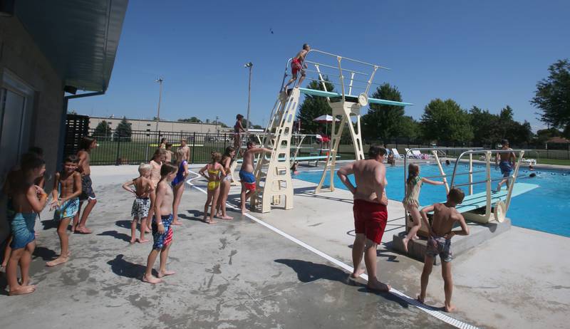 Kids wait their turn to dive off of the high-dive at Riordan Pool on Thursday, July 27, 2023 in Ottawa.
