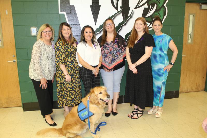 CAPE board members (from left) Joanne Baker, Veronica Fisher, Liv DeLeon, Melissa Pennuto, Blair Kramer and Erinn Henes stand with Leroy, Plainfield Academy’s therapy dog at the 48th Annual CAPE Awards on Tuesday, April 16, 2024. Leroy is retiring this year after serving PA for many years. The organization recognized Leroy and 95 outstanding parents, community members, teachers and staff members at the awards ceremony held at Plainfield High School-Central Campus.