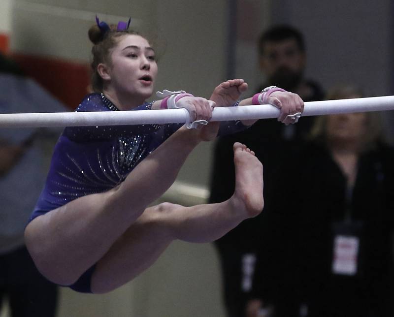 Downers Grove's Edith Condon competes on the uneven parallel bars during the IHSA Girls State Gymnastics Meet at Palatine High School on Saturday, Feb. 17, 2024.