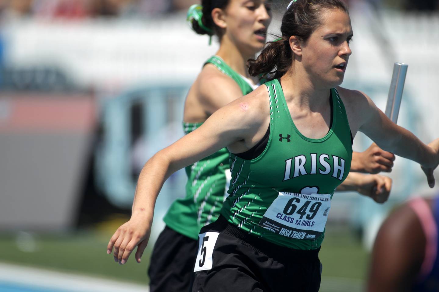 Seneca’s Anna Bruno gets the hand-off for the third leg of the 1A 4x200-meter relay during the IHSA State Track and Field Finals at Eastern Illinois University in Charleston on Saturday, May 20, 2023.