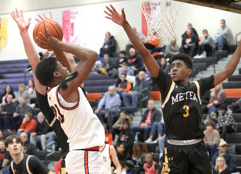 DeKalb’s Davon Grant shoots over Metea Valley's Tre Watkins during their game Friday, Jan. 19, 2024, at DeKalb High School.