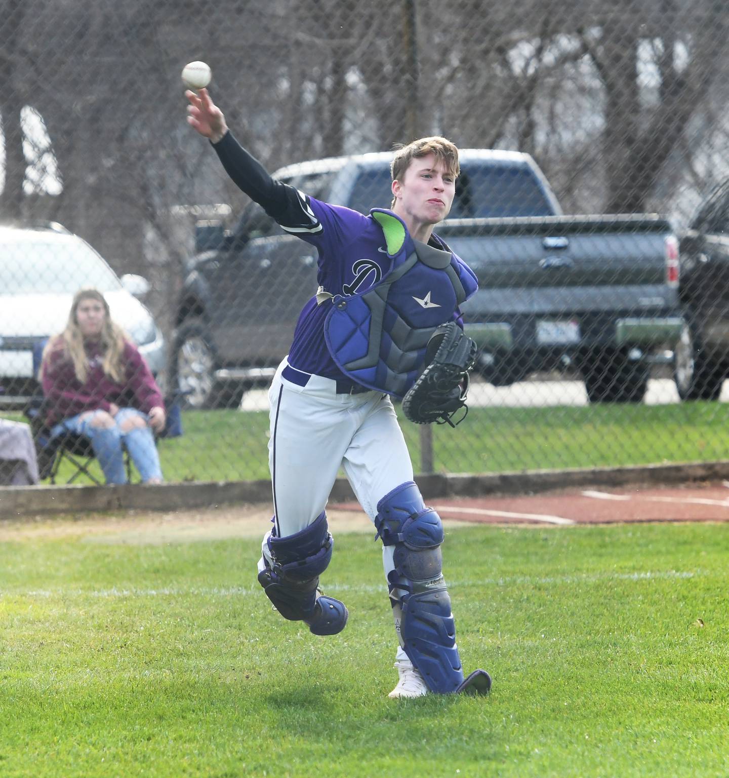 Dixon catcher Beau Evans throws to first for an out during Tuesday's game against Stillman Valley.