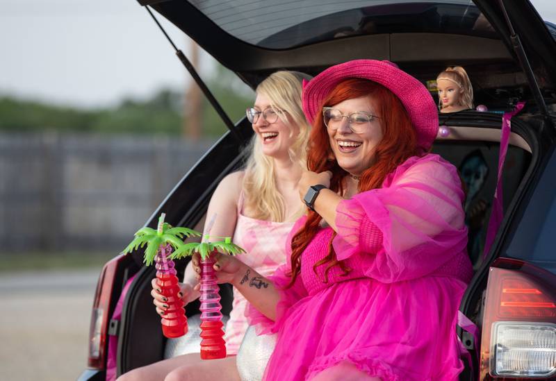 Anna Horn of Des Plaines and Ashley Bernard of Arlington Heights laugh while waiting for the "Barbie" movie premiere to begin at the McHenry Outdoor Theater on Friday,  July 21, 2023.